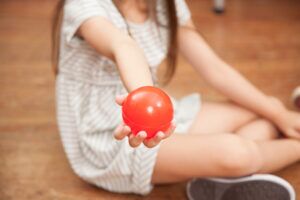 girl holding a plastic ball SBI 301098441